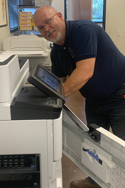 employee fixing printer